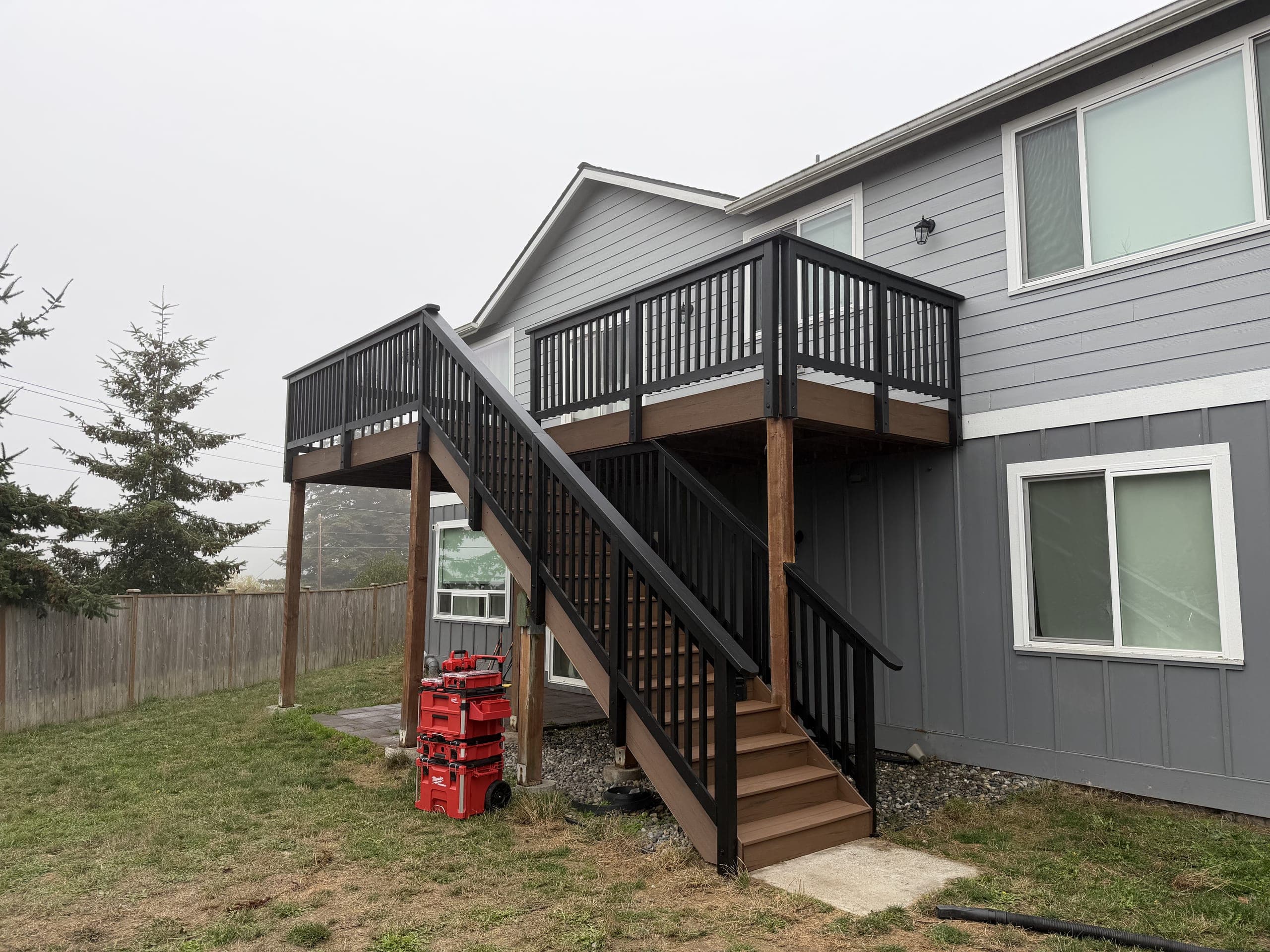 New deck and stairs on a gray two-story house